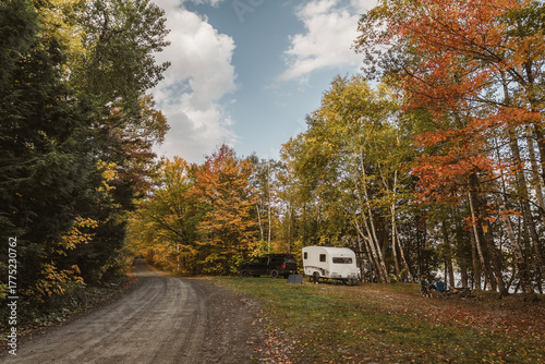 Camper at a campsite in the Maine woods with fall foliage