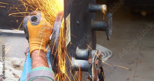 Worker or plumber using a cutting disc to cut metal