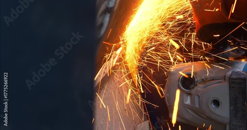 Worker or plumber using a cutting disc to cut metal