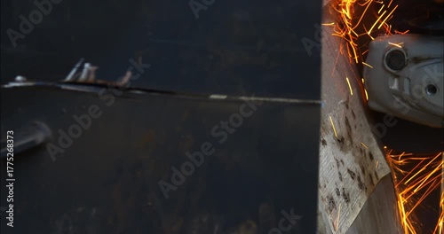 Worker or plumber using a cutting disc to cut metal