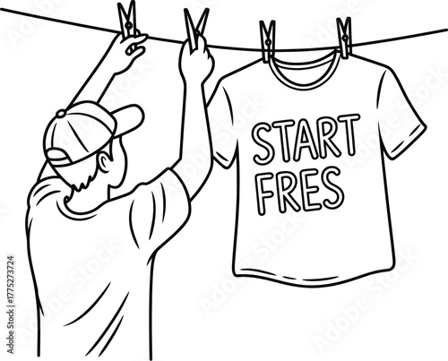Man hangs t-shirt with 'start fres' text on clothesline to dry