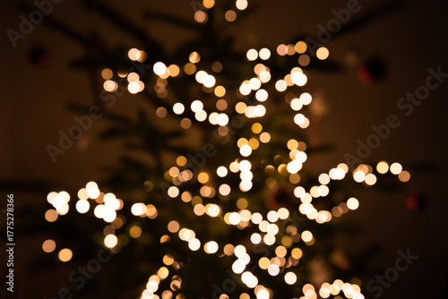 Blurred Christmas lights bokeh effect with warm golden glow background texture