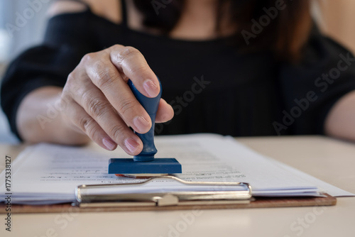 Εκτύπωση καμβά Close-up of a businessperson stamping a contract document, symbolizing approval, legal agreement, successful deal, authorization, and official corporate paperwork process