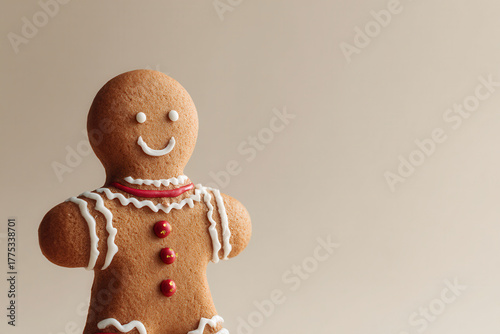 closeup of gingerbread man decorated with festive embellishments against clean background
