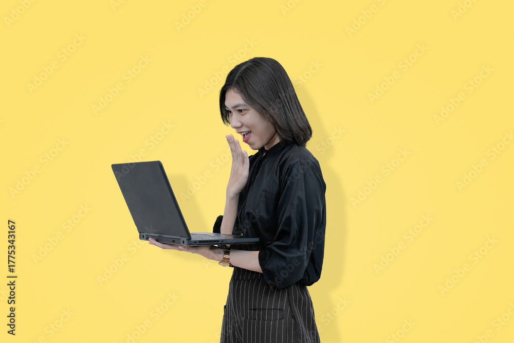 Naklejka premium Surprised woman using laptop, bright yellow background, online work concept