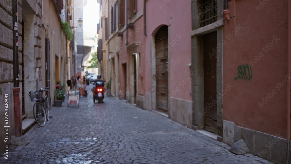 Fototapeta premium Narrow cobblestone alley captured defocused with soft bokeh and shallow depth of field; background backdrop copyspace calm.