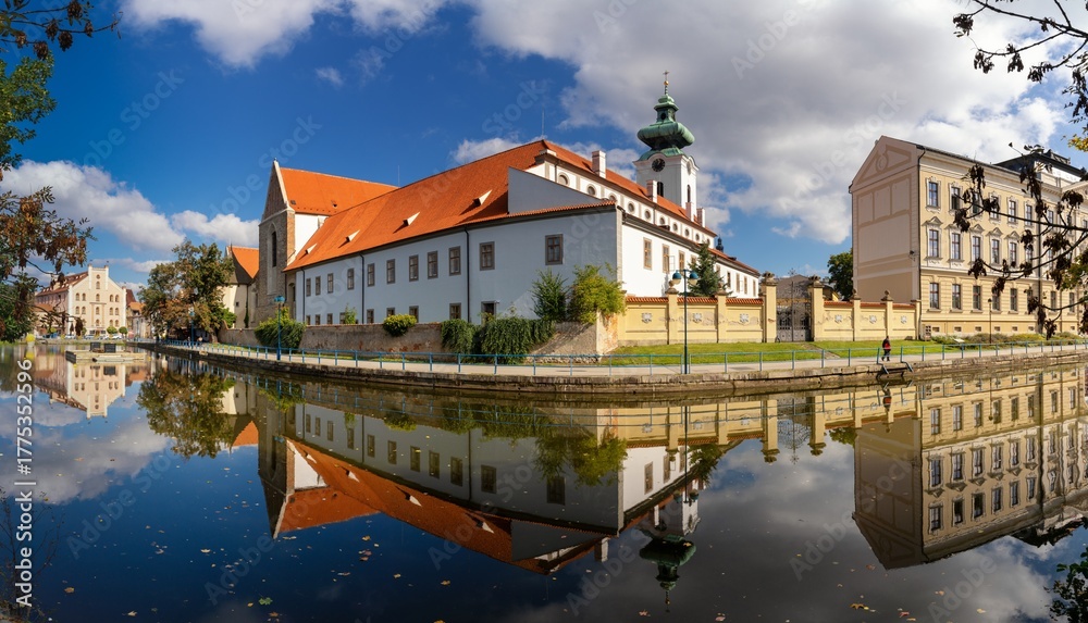 Obraz premium view of the historic Dominican monastery on the Malse River in downtown Ceske Budejovice with reflections and autumn colours