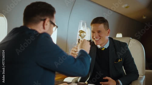 Successful business partners celebrating a profitable deal with a champagne toast while traveling together in a luxury private jet, enjoying a first-class flight and their wealthy lifestyle