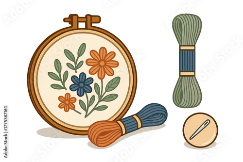 Traditional embroidery hoop with floral pattern, colorful thread skeins, and sewing needle on white background