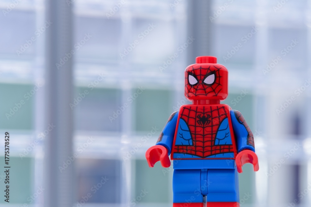 Naklejka premium Tambov, Russian Federation - January 24, 2025 Lego Spiderman minifigure standing in front of office building. Close-up