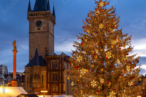 Christmas tree glowing in Old Town Square Prague at dusk