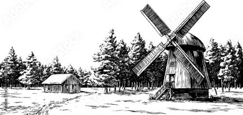 Winter scene with snow-covered windmill and wooden blades in rural setting