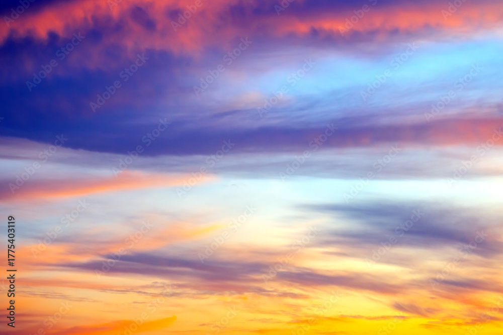 Fototapeta premium Colorful sunset sky over a tranquil landscape during evening hours