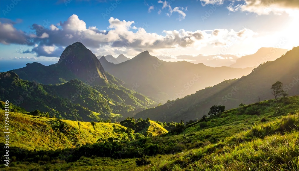 Fototapeta premium Majestic mountain range bathed in sunlight, creating shadows across lush green valleys and hills, under a cloudy sky