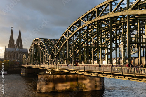 Cologne, Germany - October 26, 2025: Train Crossing Hohenzollern Bridge with Cologne Cathedral in Background