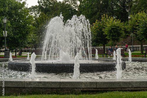 Main square and modern fountain in the Spa Park of Krynica Zdroj, Poland, surrounded by historic resort architecture.
