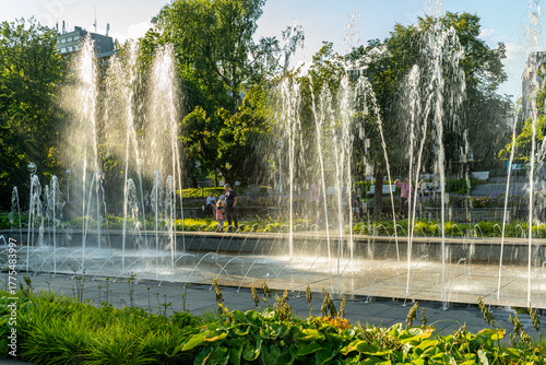 Main square and modern fountain in the Spa Park of Krynica Zdroj, Poland, surrounded by historic resort architecture.
