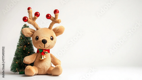 Cute plush reindeer toy with bauble antlers and a tiny Christmas tree, isolated on a white background.