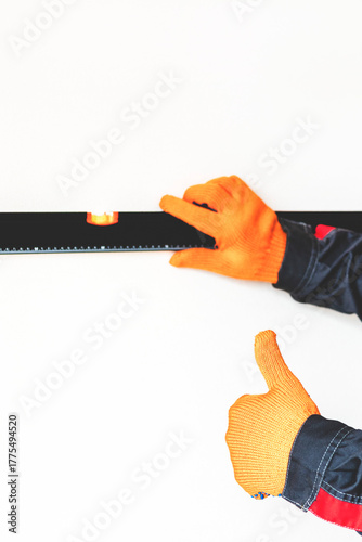 Worker's hands with bubble level.
