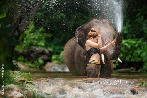 Happy female bathing elephant by the river.