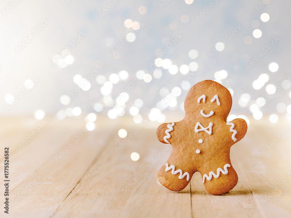 Fototapeta premium Christmas gingerbread cookies with Christmas decorations and garland with bokeh on wooden background. Christmas card design element.