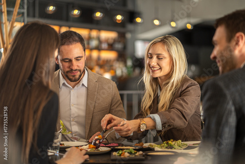 Friends enjoying a meal together at a stylish restaurant