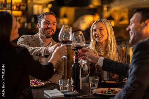 friends toasting with red wine at a restaurant