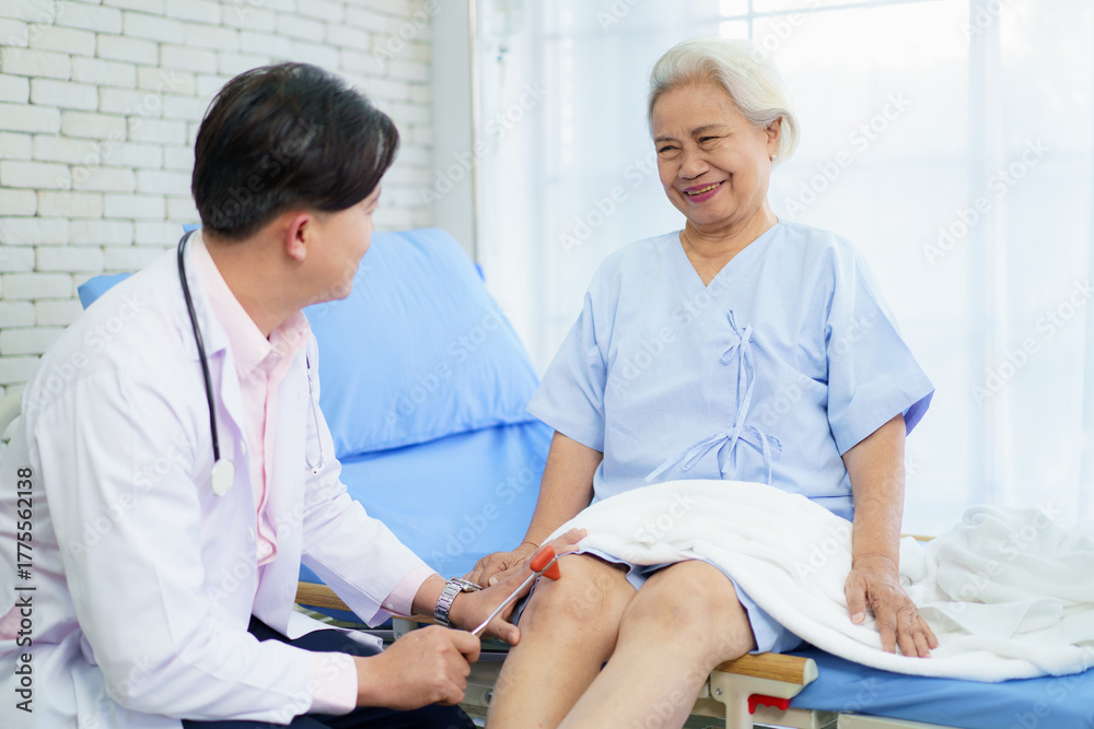 Fototapeta premium Doctor checking elderly patient’s knee for osteoarthritis.