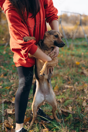 Woman Hugging Rescued Mixed-Breed Dog Outdoors