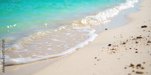 Vibrant turquoise ocean waves gently lapping onto a pristine, sunlit Miami Beach shoreline. A serene, eye level view of the Miami Beach shoreline. Crystal clear, vibrant turquoise ocean water gently