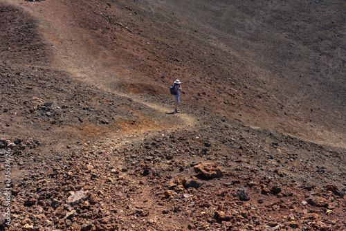 Woman taking photos on volcanic trail