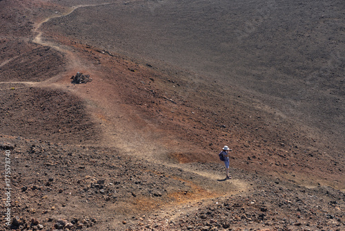 Woman taking photos on volcanic trail