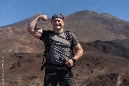 Hiker flexing with Teide in background