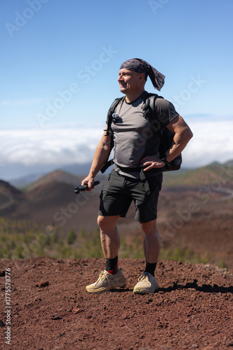 Confident hiker above the clouds