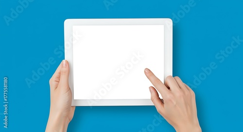 Woman using digital tablet with blank white screen perfect for mockup template or design promotion on blue background ideal for presentation