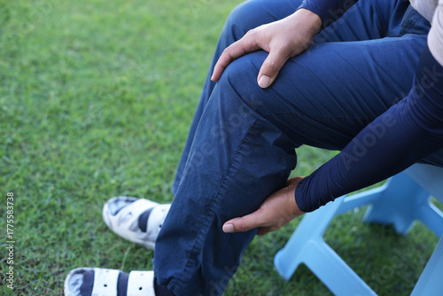 Man athlete gets pain after exercise and It happens often in athletes over practice. Sport and traumas concept and a jogger running and feeling acute pain in knee and ankle and massaging to get relief