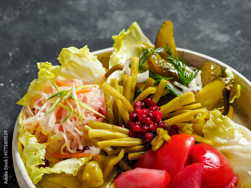Assorted snacks from fermented cabbage, cucumbers and tomatoes, green bean. Decorated cranberry. Fermented healthy food concept. Pickled cucumbers, marinated tomatoes. Close up