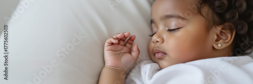 Toddler sleeping peacefully with hand open on a soft pillow