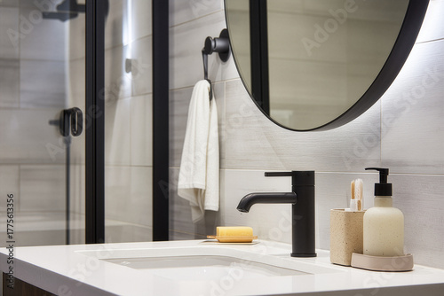A modern bathroom interior with a double vanity, black fixtures, and a large walk-in shower with black-framed glass doors. AI Generate