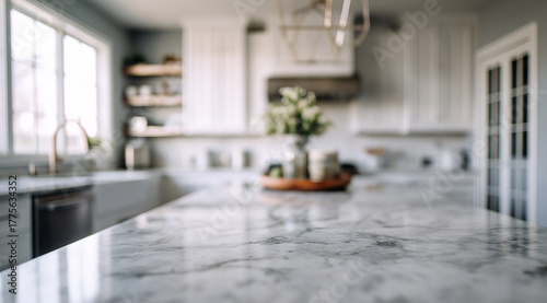 Close up of a white marble countertop in a bright modern kitchen with a blurred background grey