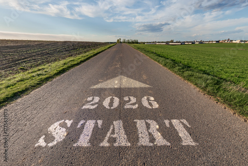 numbers 2026 and start on asphalt road highway with cracks with sunrise or sunset sky background. concept of destination in future, freedom, work start, run, planning, challenge, target, new year