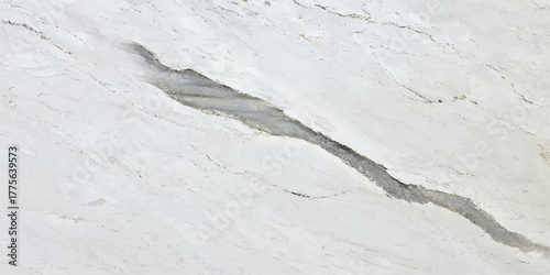 Natural winter texture: white snow background on the road with ice and frost for a cold weather pattern or surface design