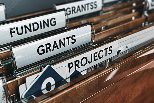 Closeup of file folders labeled funding grants grantss and projects in an office setting showcasing organization and management of financial resources and project documentation for business use