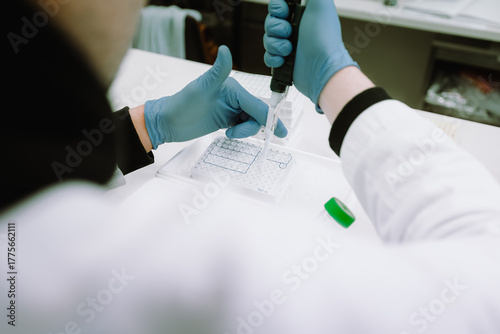 Scientist performing precise pipetting in lab