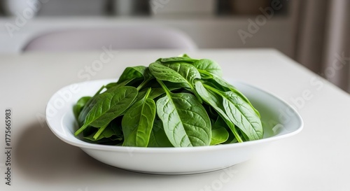 Fresh Spinach in White Bowl Standing on a White Table Ready To Be Consumed