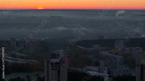Rising sun above foggy city, TV tower passing, aerial view, first glimpse, golden hour, atmospheric