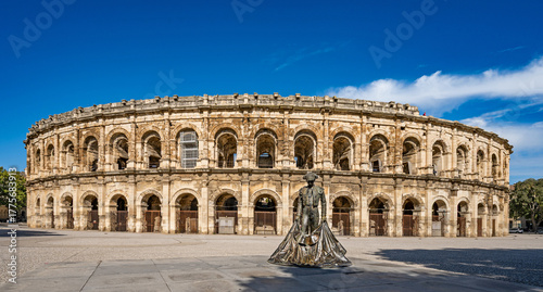 Nîmes, Provence, France – Exterior of the Arena of Nîmes with the statue of a bullfighter (torero).
