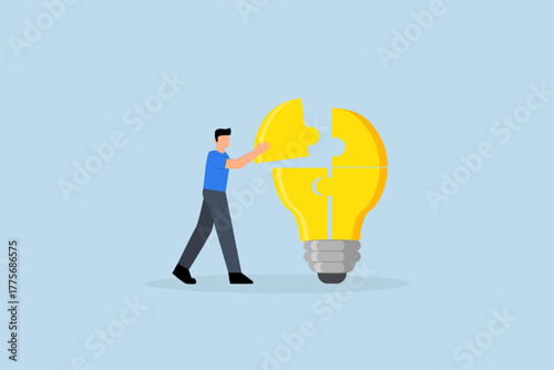 Problem solver, clever entrepreneur completing lightbulb concept puzzle by placing final jigsaw piece.