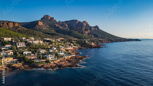 Aerial panoramic view of the Esterel Mountains near Saint Raphael, French Riviera, showing the Mediterranean Sea and luxury villas along the Cote dAzur coastline in the warm sunrise light