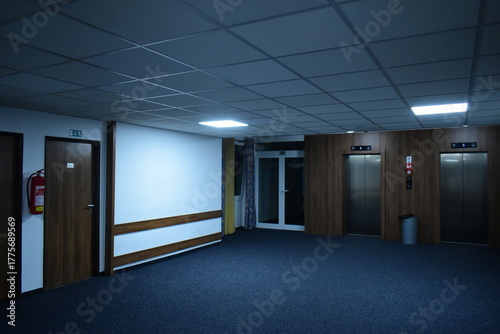 empty corridor in a hotel with elevators and an exit